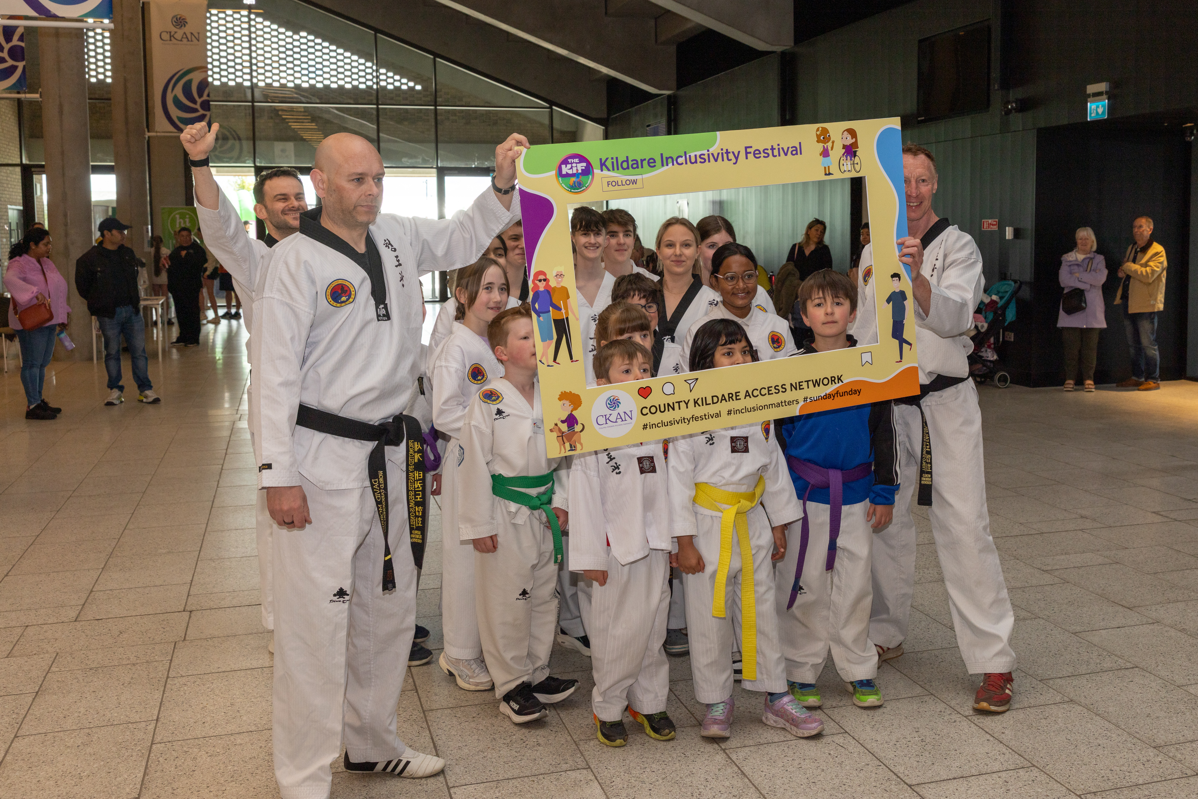 Taekwondo group with poster. 
